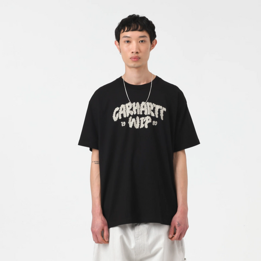 Person wearing a black t-shirt with 'Carhartt WIP' logo on a white background