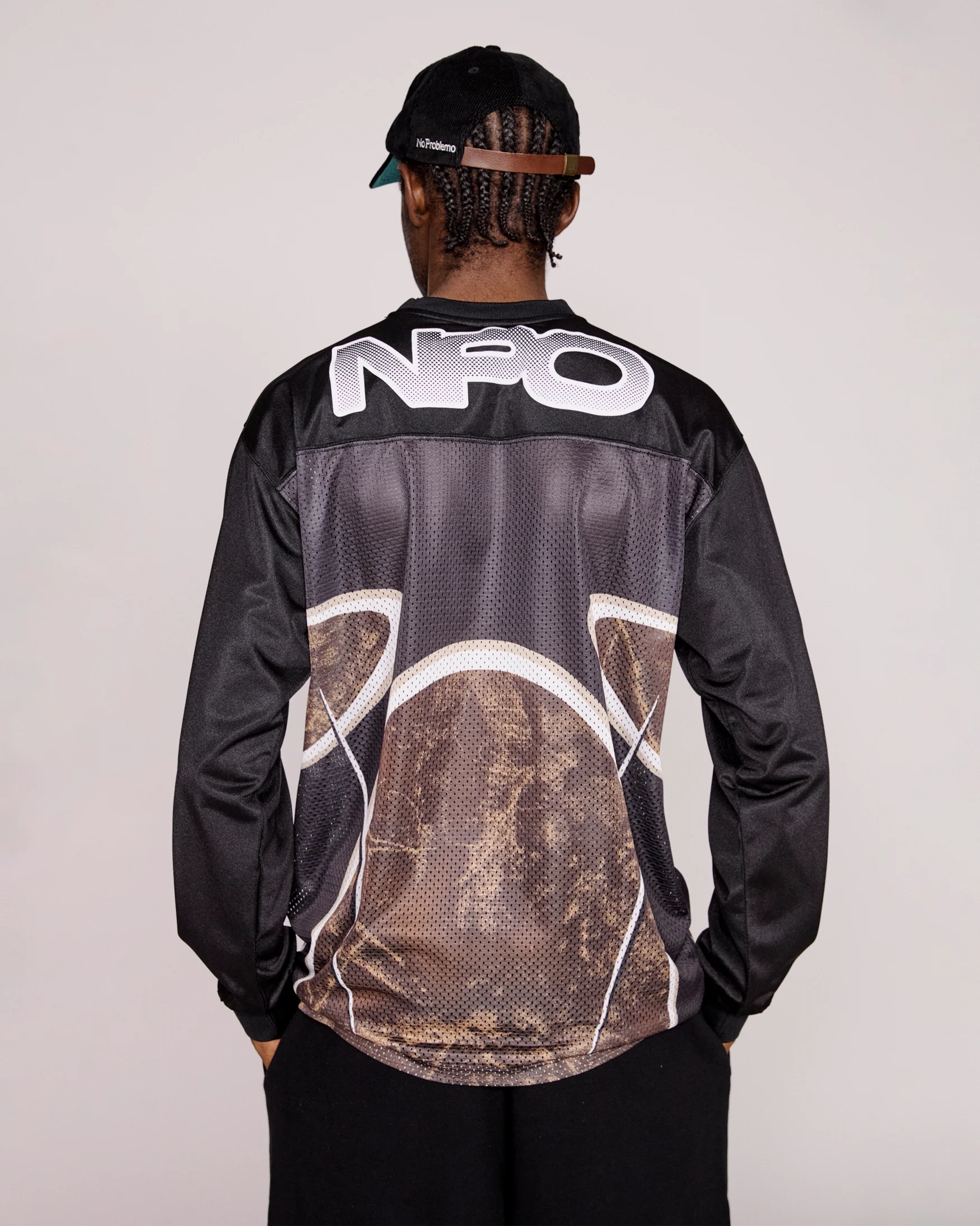 Person wearing a black top with 'NPO' branding on the back against a plain background