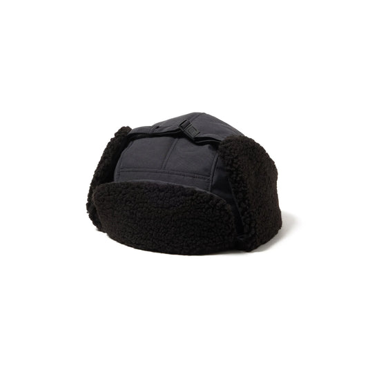 Black shearling trapper hat on a white background
