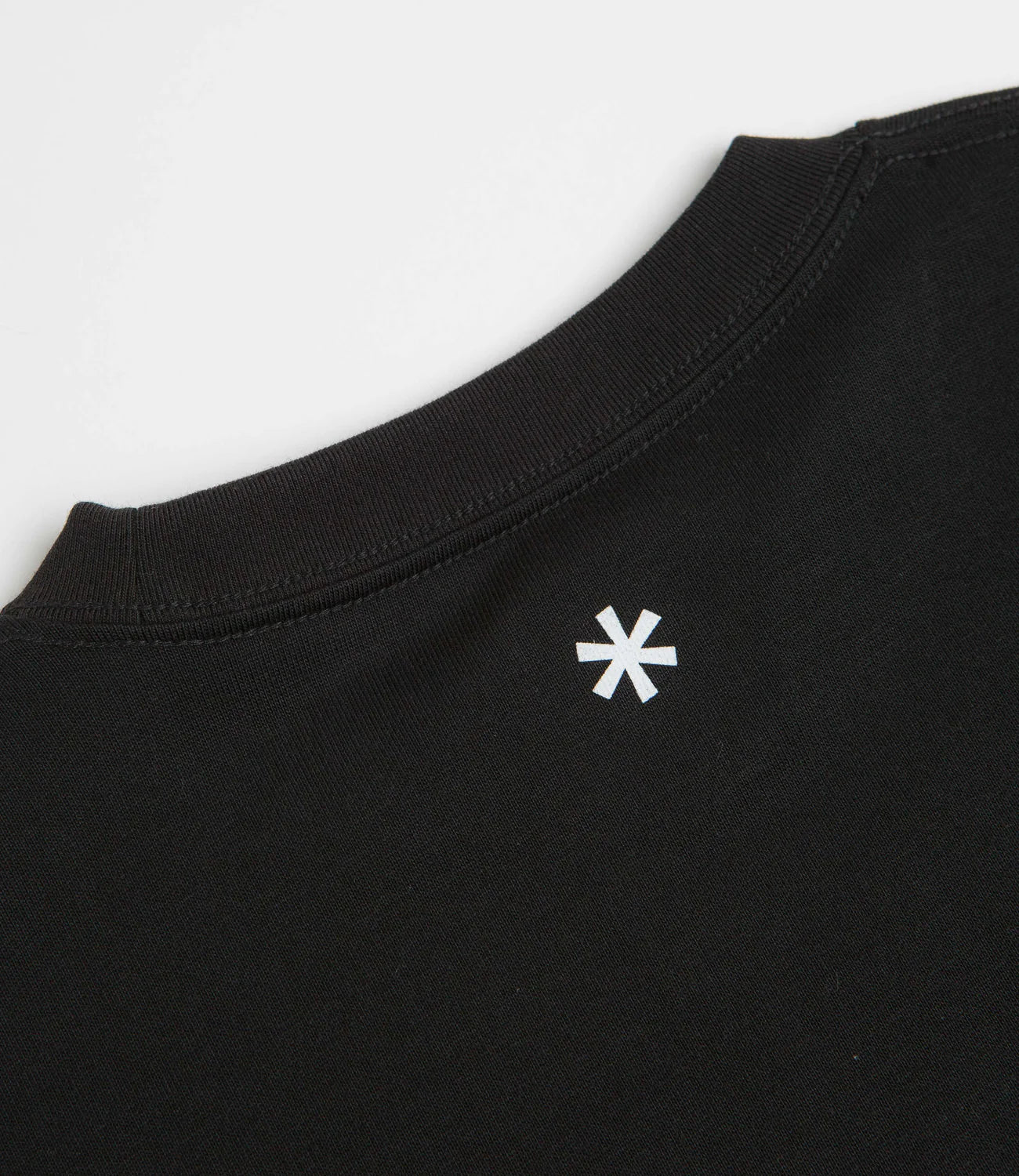 Black t-shirt with a white logo on a light gray background