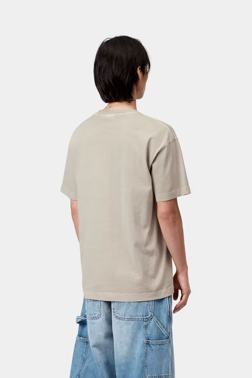 Person wearing a beige t-shirt and blue jeans on a white background