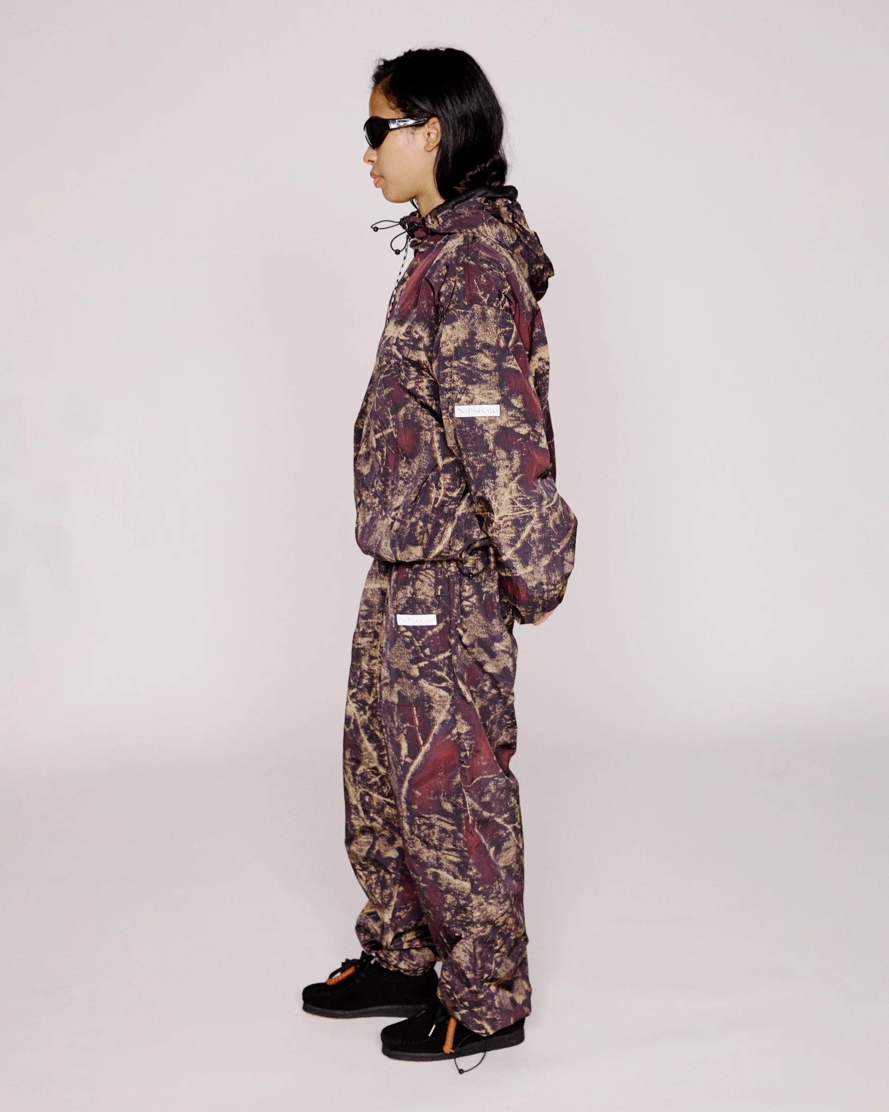 Person wearing a camouflage snowsuit on a white background