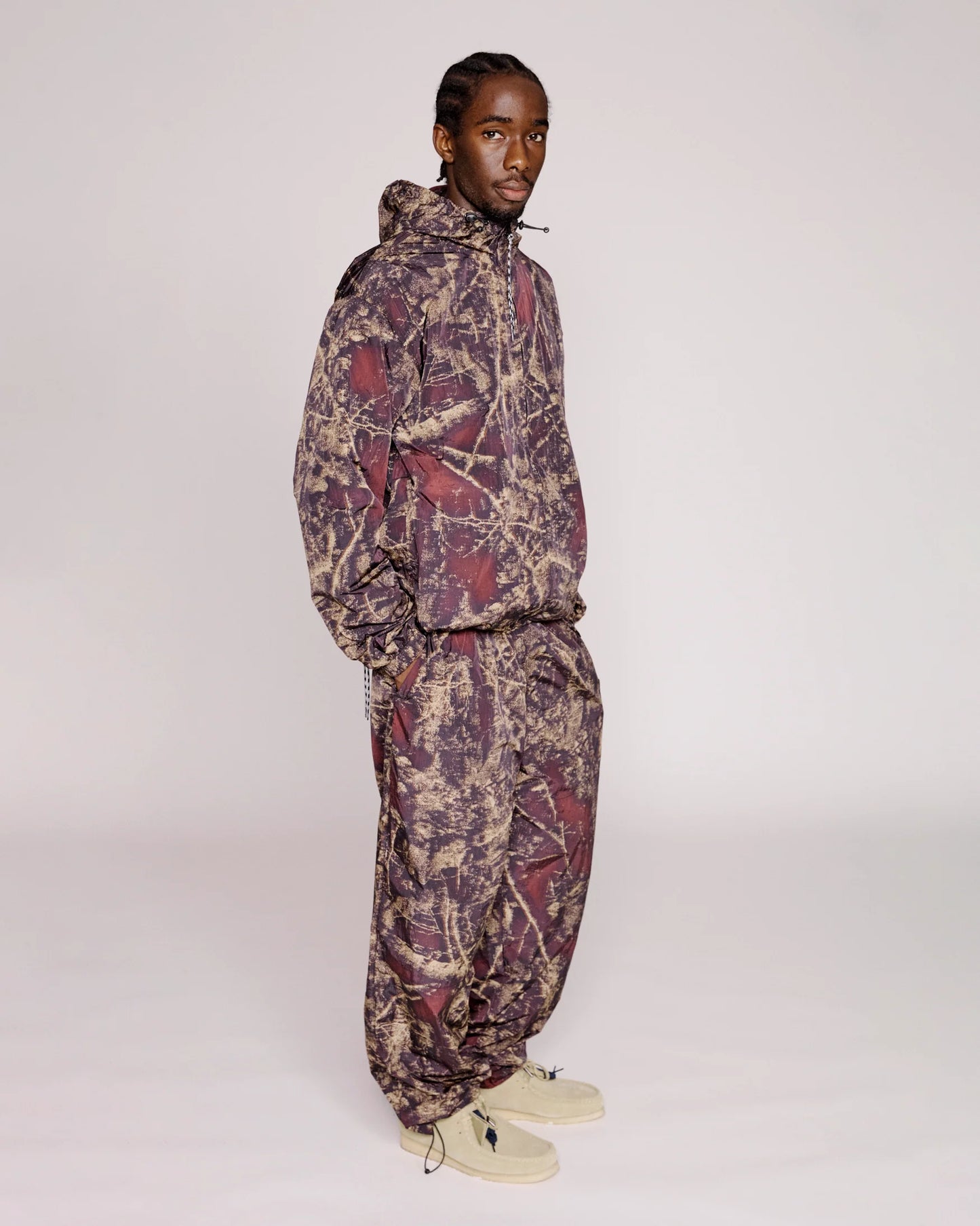 Person wearing a patterned outfit on a plain background