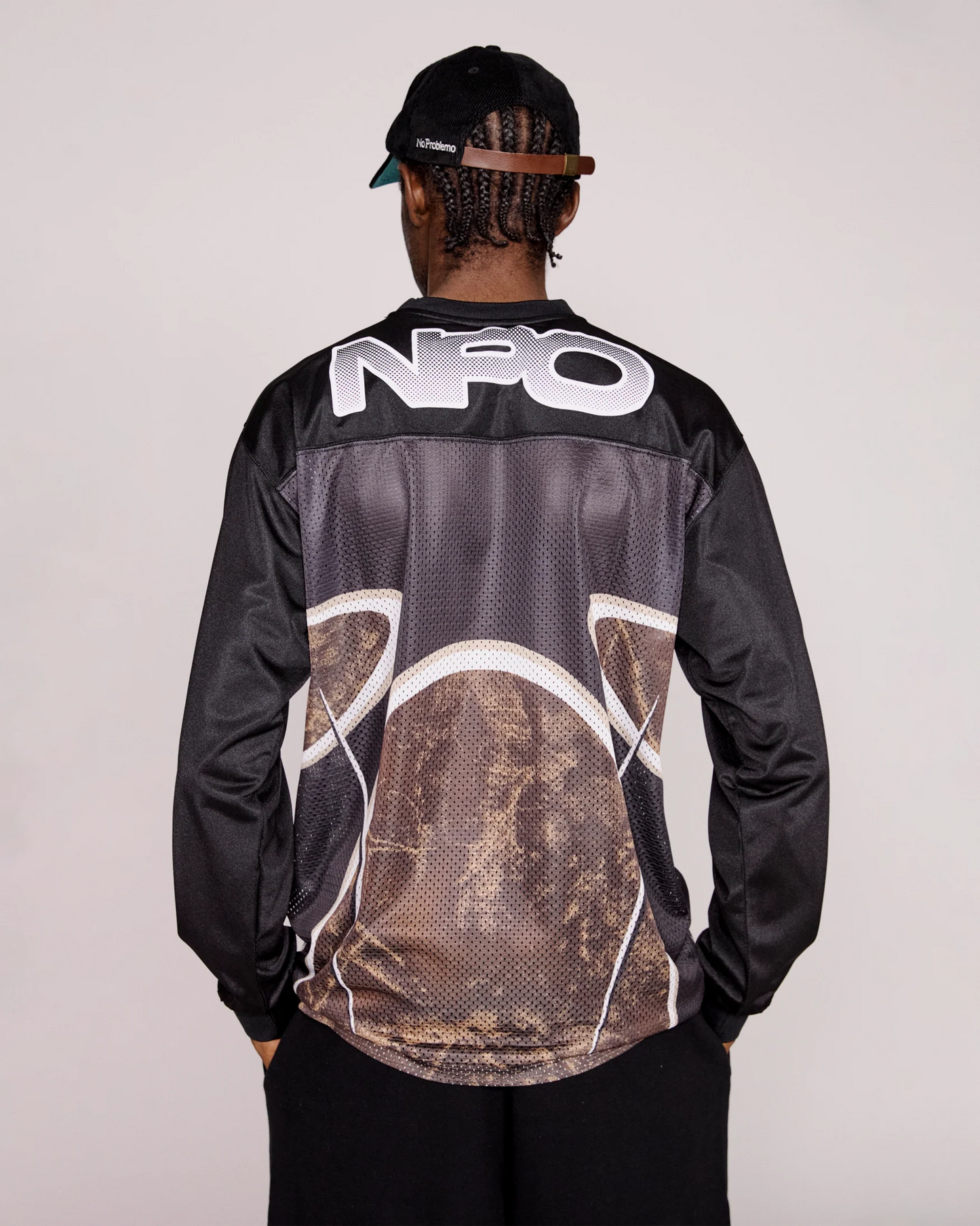 Person wearing a black top with 'NPO' branding on the back against a plain background