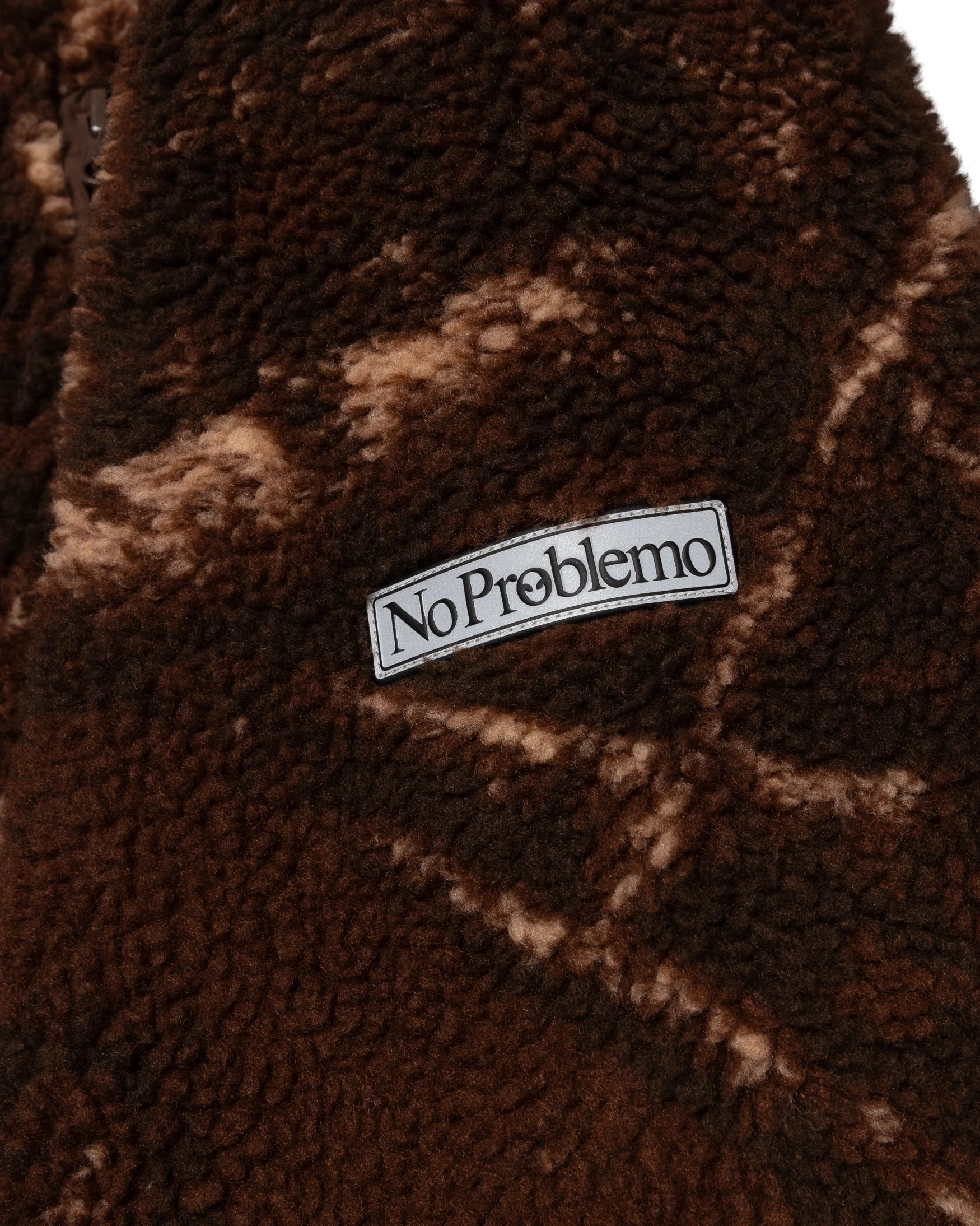 Brown textured fabric with 'No Problemo' label
