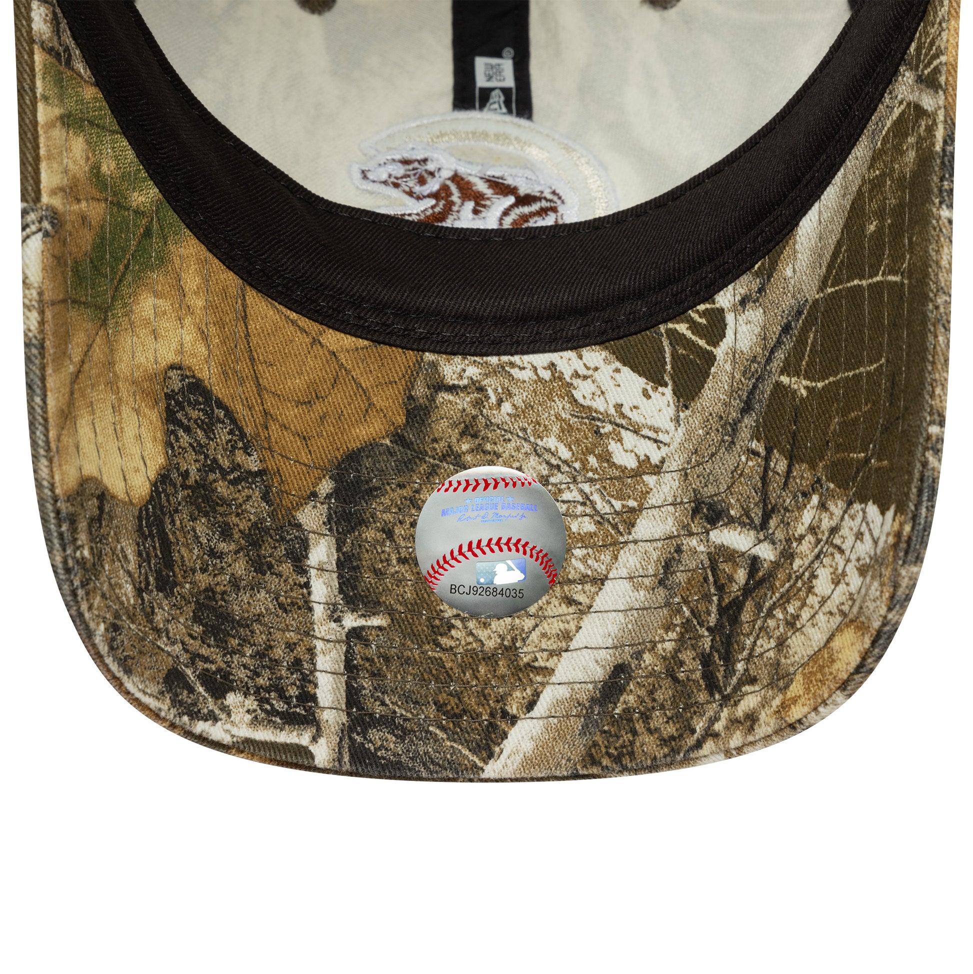 Camouflage baseball cap with a baseball on a white background